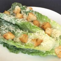Caesar Salad · Full Leaf Salad, Heart of Romaine, Shaved Parmesan, Toasted Croutons, Creamy Caesar Dressing.