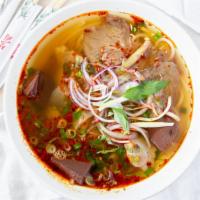 Spicy Beef Noodle Soup · Bun bo hue, beef, pork hock, tendon, pork blood with big rice Vermicelli noodle. Spicy