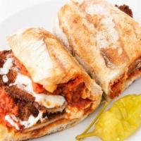 Chicken Parmigiana · Breaded chicken topped with marinara, mozzarella, and Parmesan on a baguette.