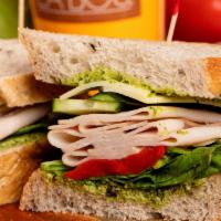 Mediterranean Turkey · Turkey, roasted red bell peppers, provolone cheese, field greens, cucumber and pesto on waln...
