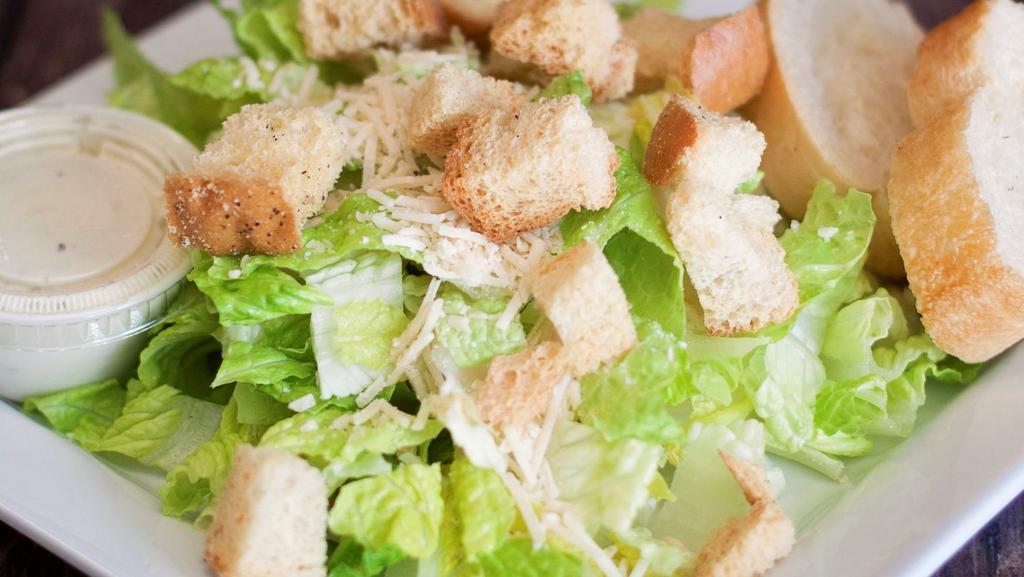 Caesar Salad · Romaine lettuce asiago cheese and croutons tossed in lemony caesar dressing.