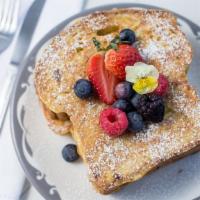 Brioche French Toast · Fresh baked brioche bread. Topped with fresh fruit and served with real maple or boysenberry...