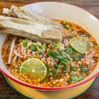Tom Yum Noodle Pork Ribs · Street style spicy lime noodle soup, ground pork and tendered pork ribs, crushed peanuts wit...