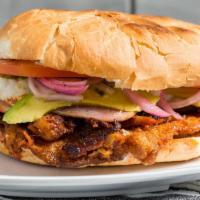 Torta Cubana · Telera torta style bread, lightly toasted it includes a light spread of beans, Milanesa, moz...