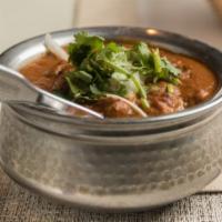 Goat Curry · Cubes of goat cooked in onion and tomato sauce with traditional Indian curry.