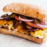 #2 Ham & Bacon Breakfast Sandwich · Two eggs, ham, bacon, cheddar cheese with the works on our ciabatta roll.