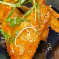 Sweet Chili Wings · Sweet chili sauce garnished with green onions.