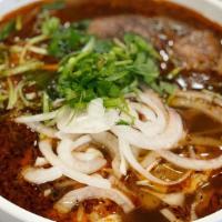 Bun Bo Hue · Spicy beef noodle soup served with three different cuts of beef, fresh vegetables and herbs