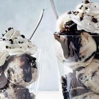 Cookies & Cream Dazzler Sundae · Cookies and cream ice cream layered with hot fudge and chocolate cookie pieces topped with w...