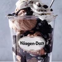 Rocky Road Dazzler Sundae · Rocky road ice cream layered with hot fudge and chocolate cookie pieces topped with whipped ...
