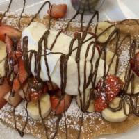 The Grand Nutella Crepe · Strawberries, fresh bananas, Nutella, and whipped cream. Served fresh and sprinkled with pow...