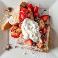 The Nut Kracker Toast · Strawberries, chocolate chips, macadamia nuts, and whipped cream. Served fresh and sprinkled...