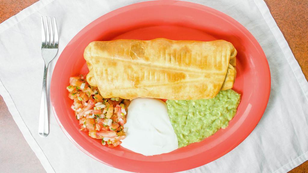 Chimichanga · Crispy fried burrito filled with rice refried beans, cheese and choice of meat topped with sour cream, guacamole and pico de gallo.
