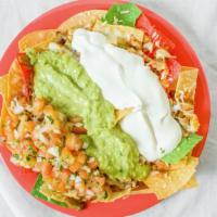 Super Nachos · Fresh chips topped with refried beans, Jack cheese, sour cream, guacamole and pico de gallo ...