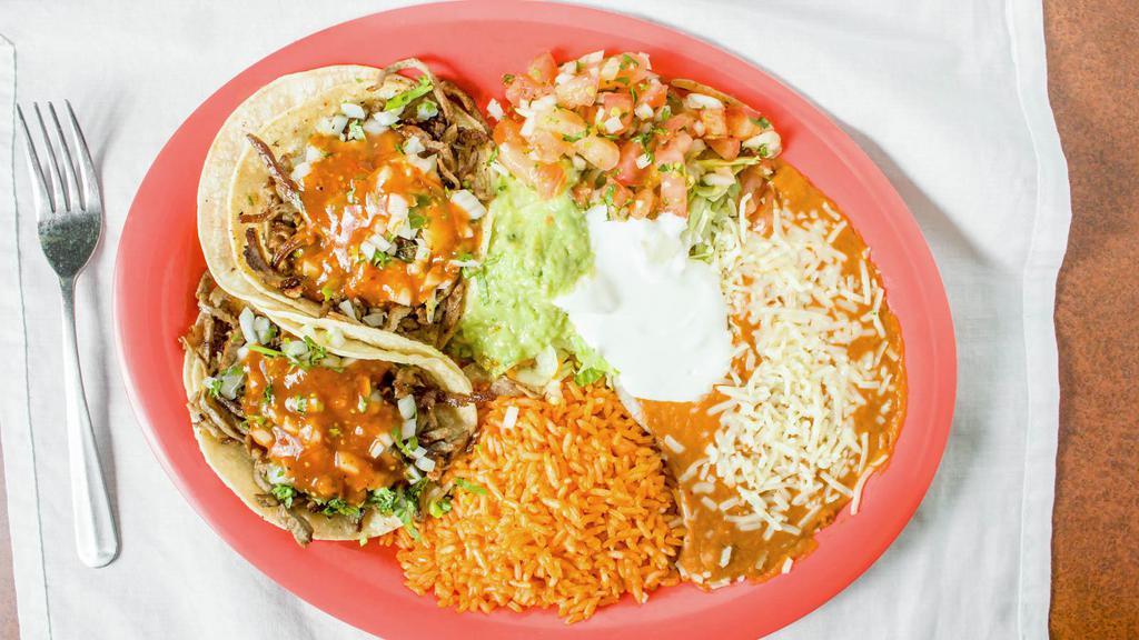 Three Tacos Plate · Served with rice refried beans salad and tortillas.
