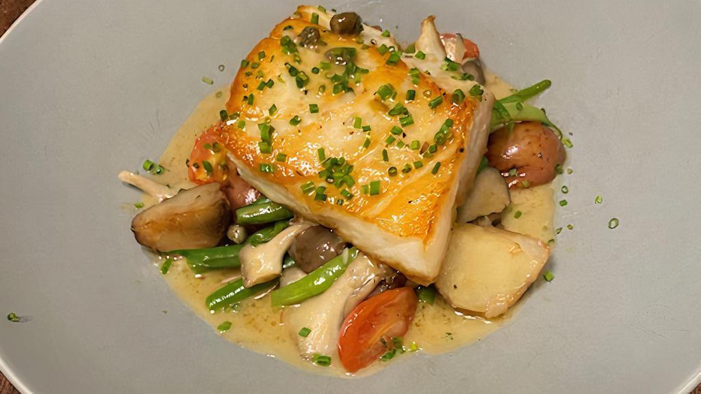 Chilean Seabass · Pan roasted chilean seabass served with oyster mushrooms, green beans, roasted potatoes, cherry tomatoes, and finished with a lemon caper butter sauce