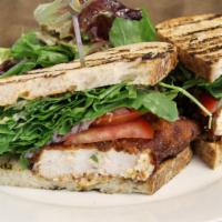 Grilled Swordfish Sandwich · Served on grilled sourdough bread with avocado, arugula, tomatoes, red onions, and pesto aioli