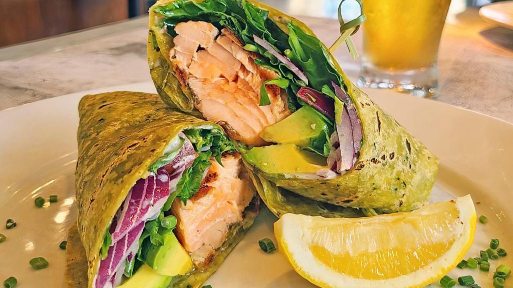 Grilled Salmon Wrap · Fresh grilled salmon with baby arugula, red onion, sliced avocado and diced tomato wrapped in a traditional flour tortilla. Served with our house made sauce. Choice of mixed greens or caesar salad.