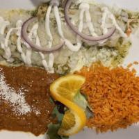 Enchiladas Suizas · Shredded chicken, topped with green sauce, cheese, cilantro, onions and sour cream.