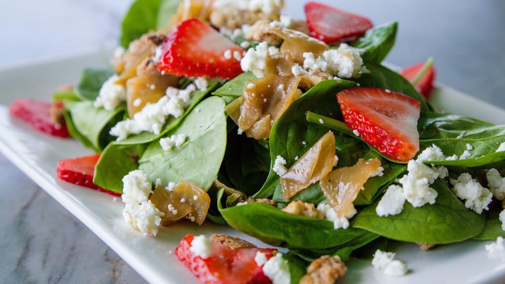Spinach Salad (Half) · Fresh spinach, caramelized onions, candied walnuts, goat cheese, seasonal berries mixed with honey champagne vinaigrette.