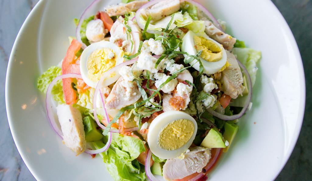 Cobb Salad (Half) · Chopped romaine lettuce, bacon, avocado, chicken, eggs, red onions, diced tomatoes, fresh basil, and gorgonzola cheese, served with ranch or bleu cheese dressing.