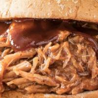 Bbq Smoked Pulled Pork Sandwich · Special seasoned pork slowly roasted and smoked topped with BBQ sauce and coleslaw on the si...