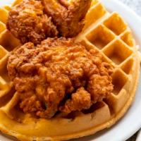 Chicken & Waffles · our signature waffle topped with 2 pieces of bone-in fried chicken served with syrup