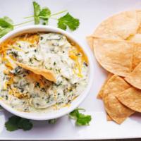 Spinach Artichoke Dip · A perfect blend of smoked artichoke heart, spinach and three cheese served with tortilla chi...