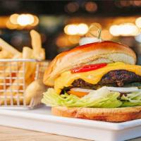American Burger · 1/2 lb ground steak topped with American cheese, lettuce, tomato, onions and pickles on a wa...