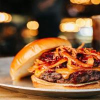Smokehouse Burger · 1/2 lb ground steak topped with cheddar cheese, brisket, caramelized onions and chipotle chi...