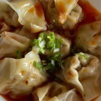 Shrimp & Pork Wontons In Chili Oil (8Pc) · NEW! wontons with shrimp and pork filling, served in our homemade chili oil, topped with sca...