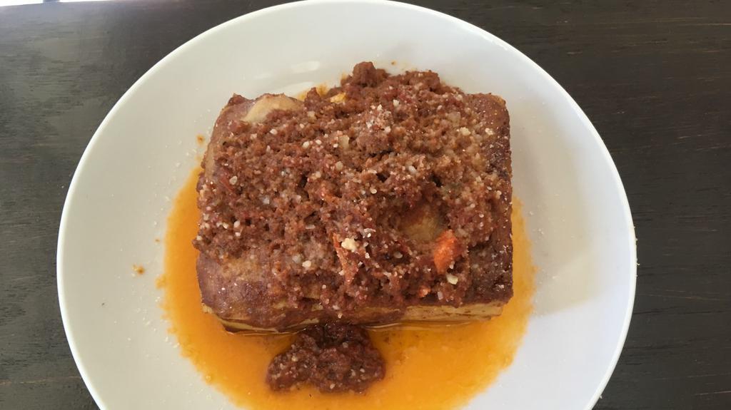 Lasagna Bolognese · Traditional homemade lasagna pasta prepared in layers of besciamella cream, bolognese meat ragu, and parmigiano cheese.