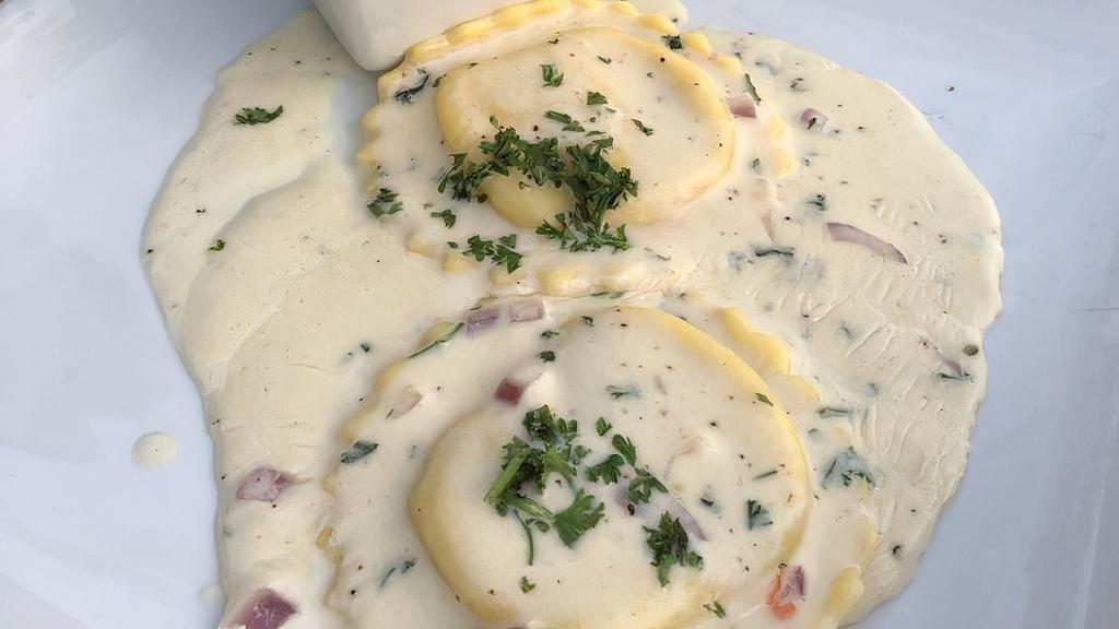 Ravioli D’Aragosta & Gamberi · Lobster and shrimp filled home-made ravioli in a creamy cognac sauce topped with a shrimp.