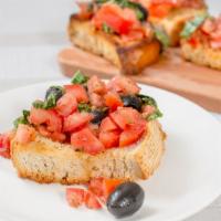 Bruschetta Alla Romana · Toasted bread topped with olive oil, tomato, basil, and black olives.
