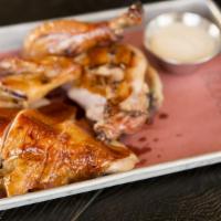 Wood-Smoked Free-Range Chicken · Finished over a wood grill. Pickled pears, white sauce.