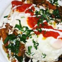 Chilaquiles · Gluten free tortilla chips, smothered in salsa Roja & Monterey jack cheese, topped with 2 eg...