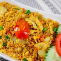 Yellow Curry Fried Rice · Eggs, peas and carrots, tomatoes, onions, and yellow curry powder.