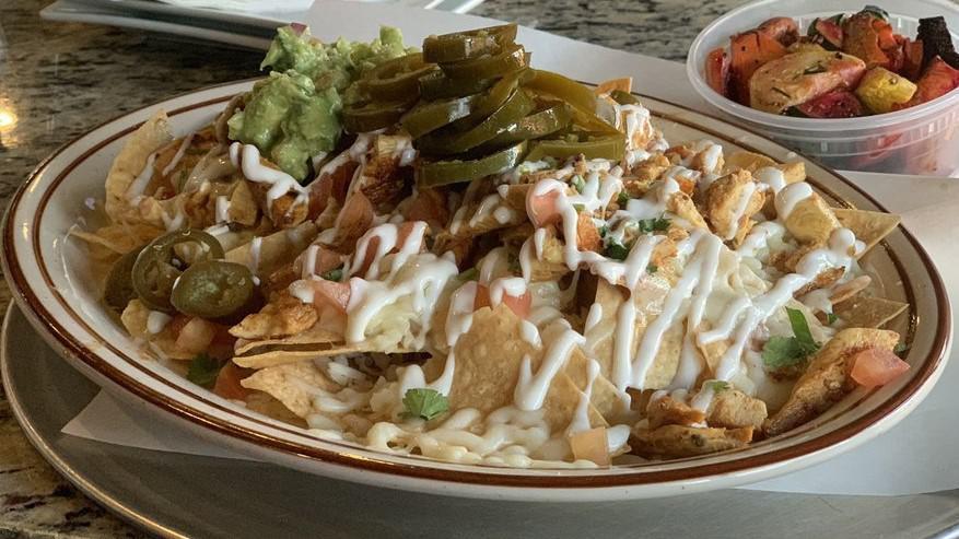 Nachos · Fried tortilla chips topped with your choice asada or chicken, refried beans, cheese, sour cream, guacamole, and pico de gallo.