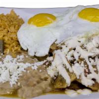 Chilaquiles · Tortilla chips in sauce topped with egg, queso fresco and sour cream.