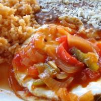 Huevos Rancheros · Two eggs sunny side up on corn tortilla with ranchera sauce.