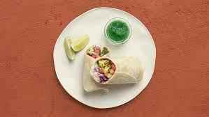 Lamb Curry Burrito · Rich lamb curry with basmati rice, diced cucumber and tomato, shredded cabbage, and mint chu...