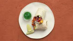 Lamb Tikka Masala Burrito · Buttery lamb tikka masala with basmati rice, diced cucumber and tomato, shredded cabbage, an...