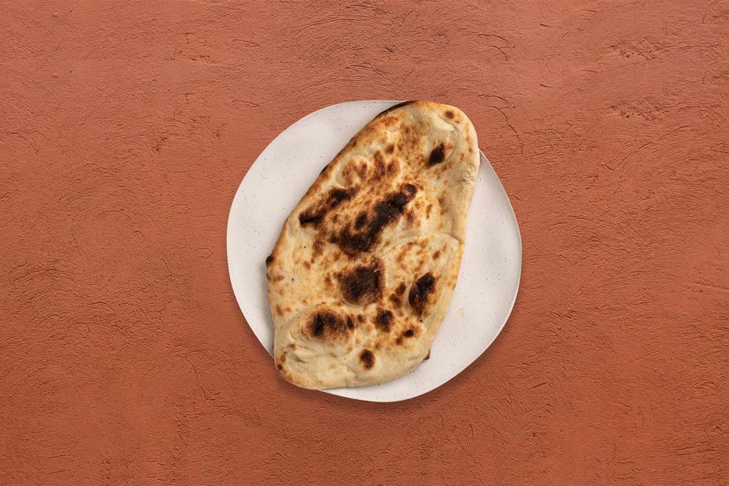 Garlic Naan (1Pc) · Tandoori baked bread topped with garlic and butter.