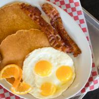 Big Deal Breakfast · Two pancakes, three eggs, two piece bacon, and two piece sausage.