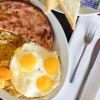 Ham & Eggs · Three eggs, one large piece of ham, hash browns, and toast.