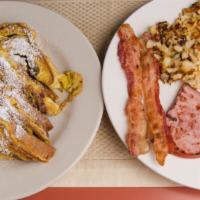 Bear’S Breakfast · Two slices of cinnamon raisin french toast, one waffle, or three pancakes. Served with two e...