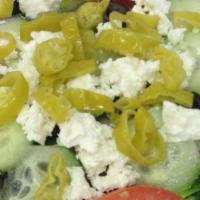 Greek Salad · Iceberg and romaine lettuce, tomatoes, red onions, cucumbers, black olives, feta cheese, and...