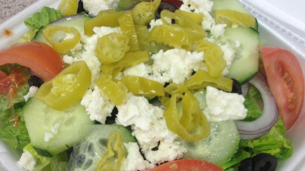Greek Salad · Iceberg and romaine lettuce, tomatoes, red onions, cucumbers, black olives, feta cheese, and pepperoncini.