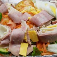 Chef Salad · Iceberg and romaine lettuce, tomatoes, cucumbers, ham, turkey, avocado, provolone, and Ameri...