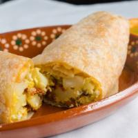 Breakfast Burrito · Egg, cheese, and potatoes included. Choice of bacon, ham and sausage.